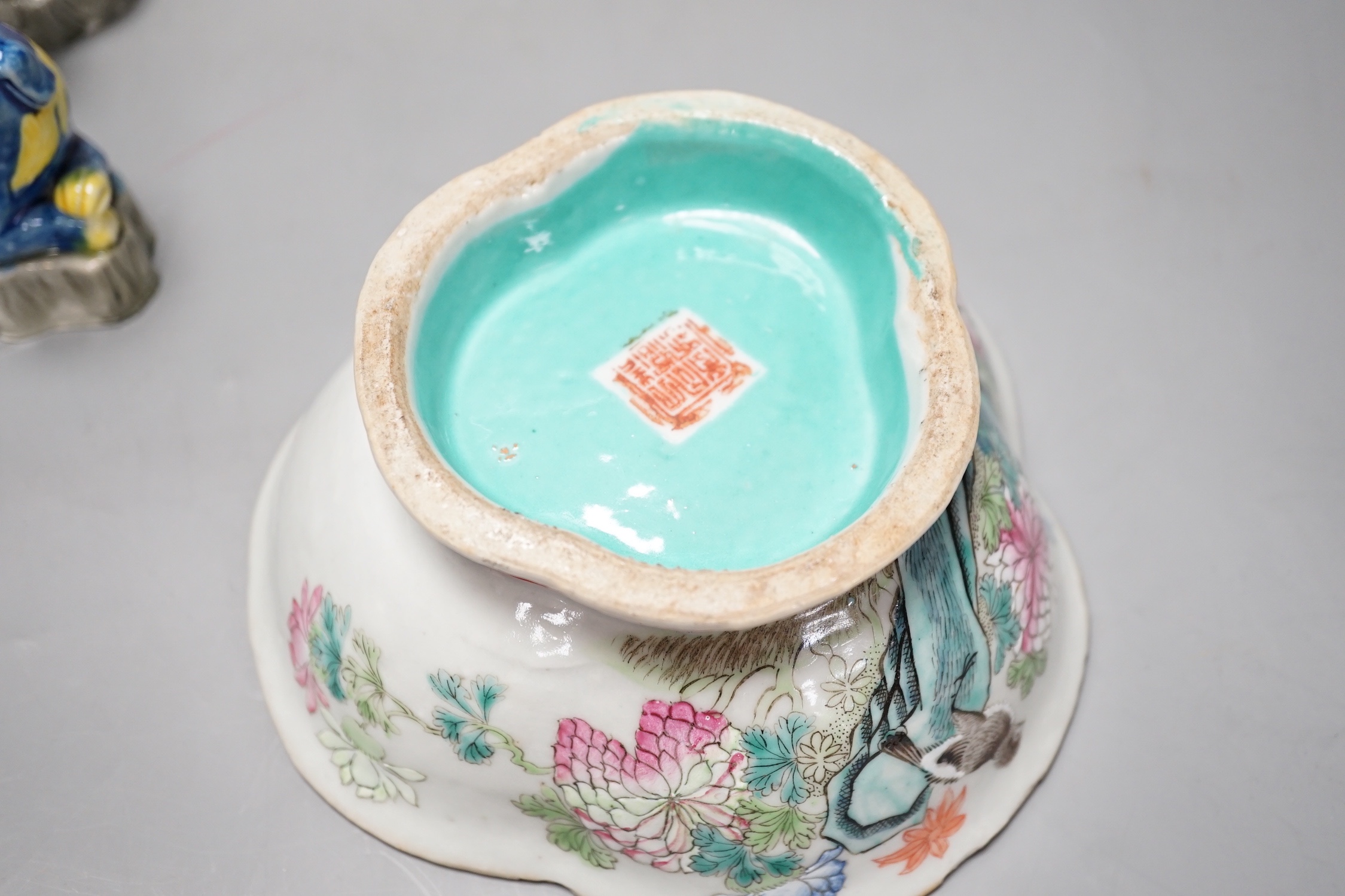 Four Chinese polychrome glazed models of lion-dogs, Republic period and a Chinese famille rose dish, Tongzhi mark, 15.5cm (5)